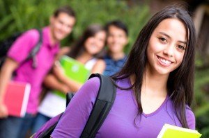 Reasons To Start A Business At University - image - student with backpack and books with friends standing behind