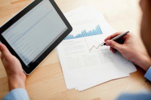 Business plan guide: researching your market & getting funding - image - man in shirt holding tablet and making notes