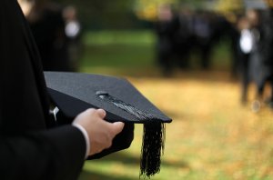 Why New Graduates make Great Entrepreneurs - image - graduate in gown holding cap