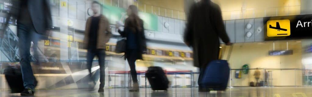 Bringing an SME into an International Market - image - blurry image people walking with suitcases