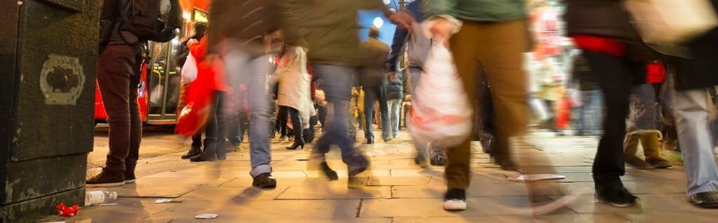 Business Success Lessons from Big Brands - image - people walking quickly with shopping bags