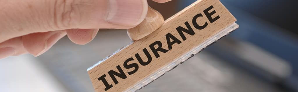 Close up of a rubber stamp that reads insurance