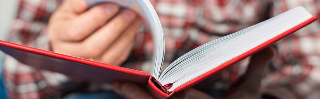 Male employee looking through a business book