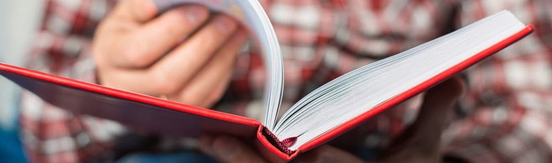 Male employee looking through a business book