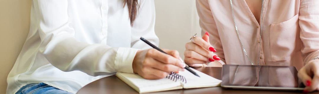 Inspiring girls to Aspire to Entrepreneurship - image - women's hands making notes in a notepad