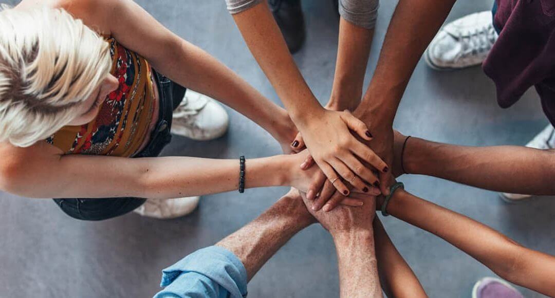 International Women's Day 2017 image - group of people placing their hands together