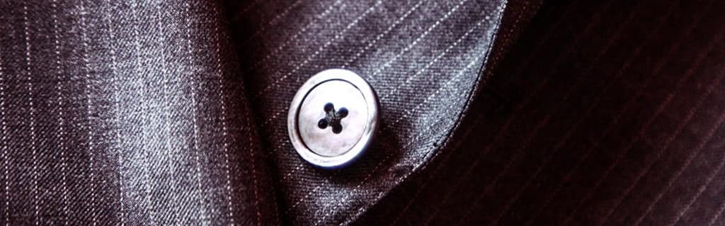 Starting a business from a passion for fashion image - black button on a stripey suit