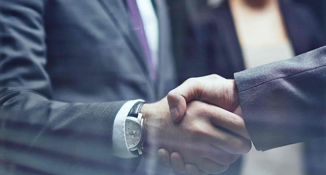 Business men wearing suits conducting a handshake