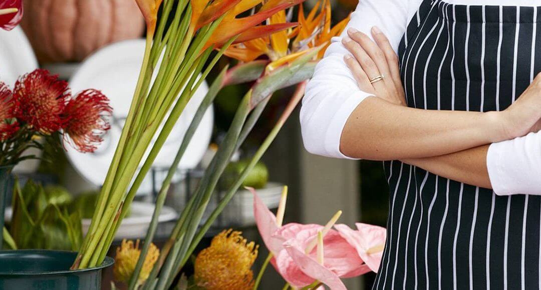 The Entrepreneurial Story Of Appleyards Tash Khan - image- woman with arms folded next to flowers