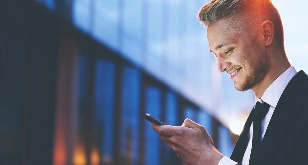 Young entrepreneur in a suit using a mobile phone