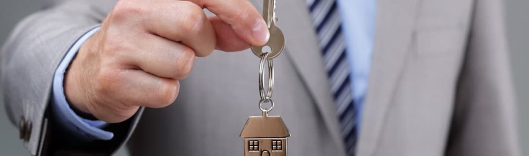Top Tips On Property Development image - man in a suit offering a bunch of keys