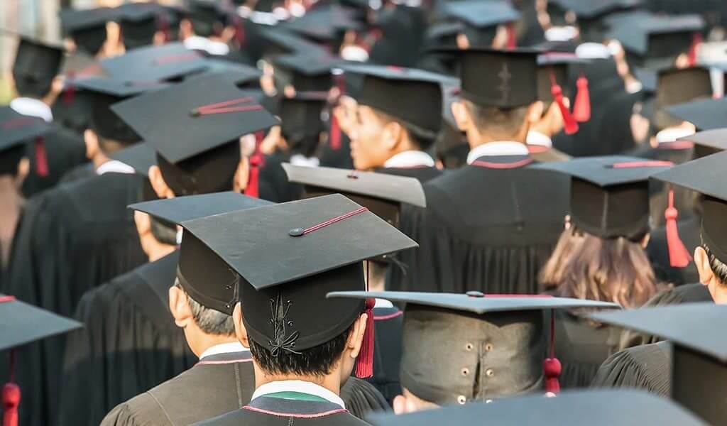 Group of students on graduation day looking toward entrepreneurship