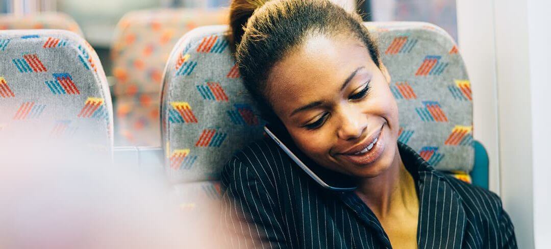 Female business owner using a mobile device on a train