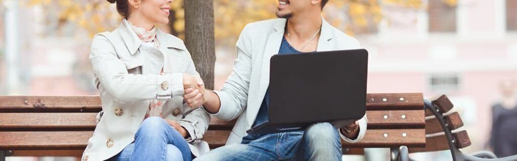 two young entrepreneurs agreeing on a business decision in a public space