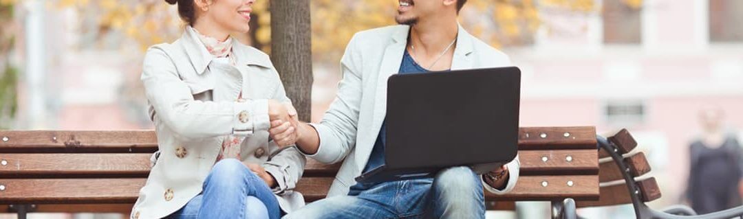 two young entrepreneurs agreeing on a business decision in a public space