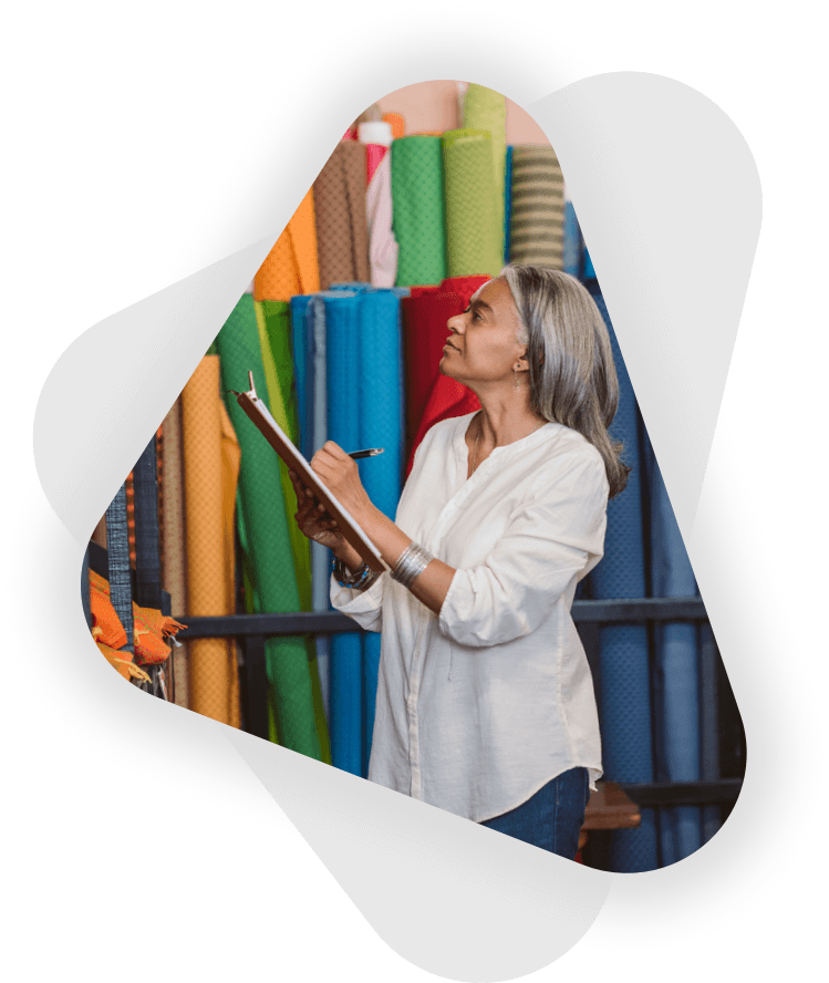 female business owner doing a stock check in fabrics store